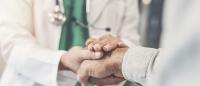 Health worker holding patient's hand